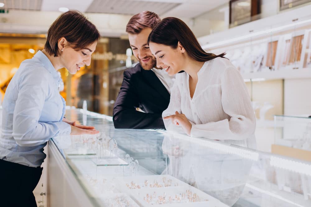 Couple at jewelry shop choosing a necklace together